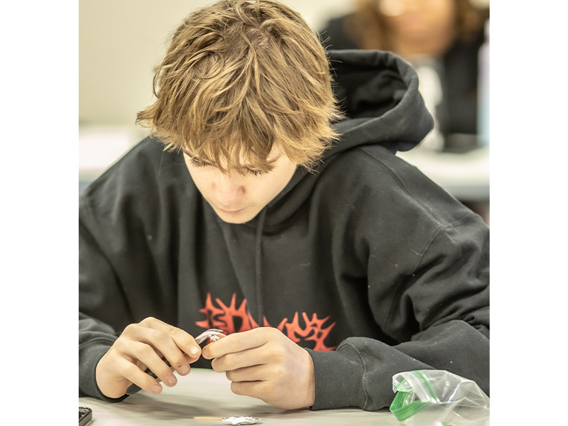 Blonde mail student working at a desk