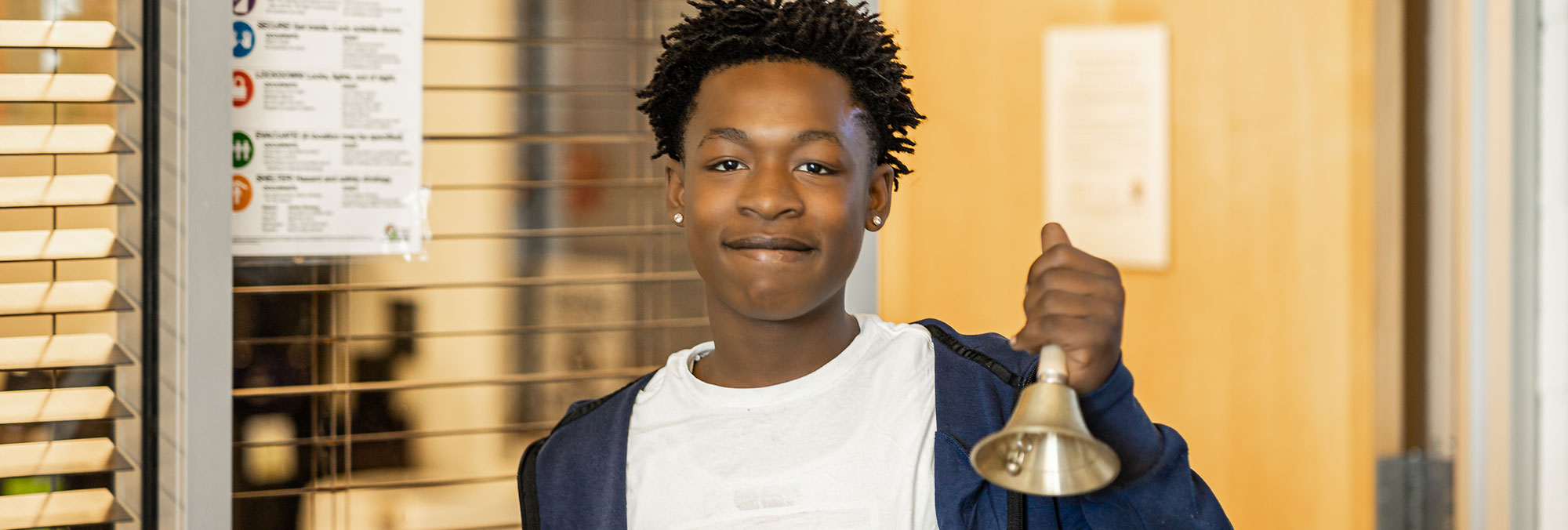 Student holding a bell
