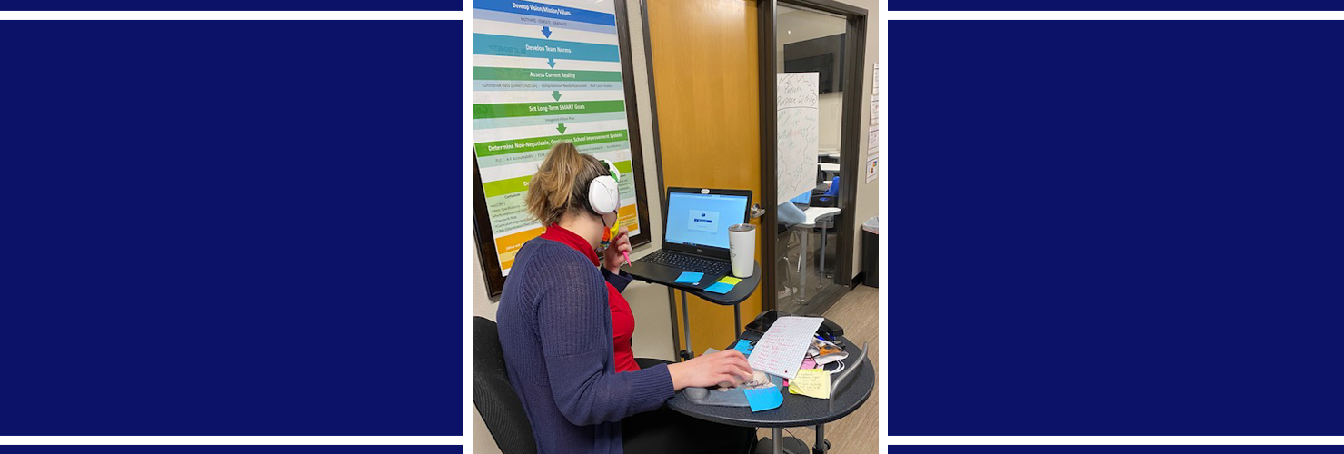 Staff member at a desk with laptop