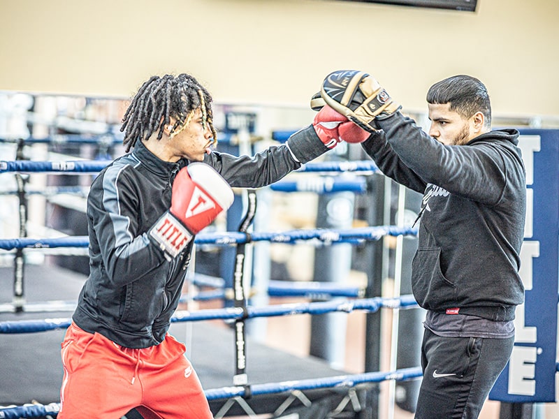 two males practicing boxing