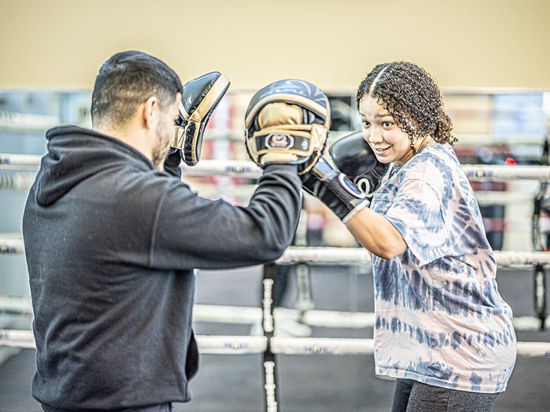 female and male practicing boxing