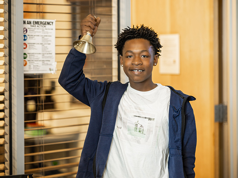 Student ringing a bell